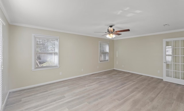 empty room featuring light wood-type flooring and crown molding