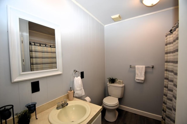 full bath featuring toilet, curtained shower, vanity, wood finished floors, and baseboards