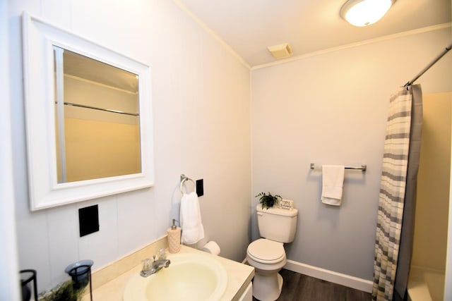 145 Deerpath St, Ozark, AL 36360 - full bathroom with vanity, toilet, ornamental molding, a shower with shower curtain, and wood finished floors