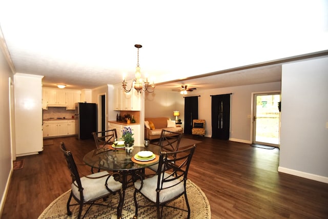 dining space with dark wood-type flooring, baseboards, and ceiling fan with notable chandelier