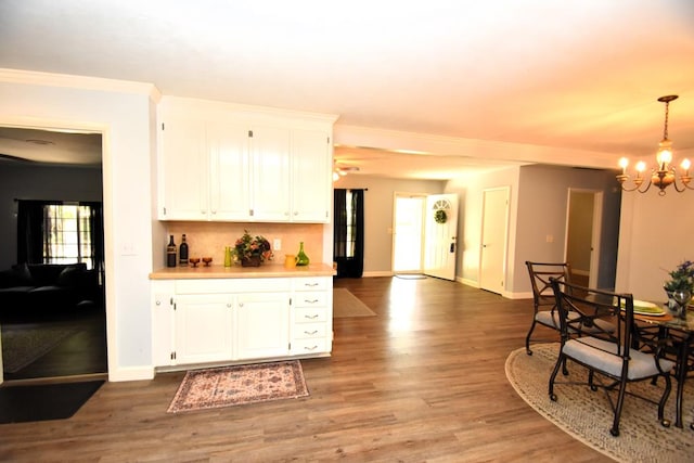 145 Deerpath St, Ozark, AL 36360 - kitchen with a chandelier, baseboards, light wood finished floors, and crown molding