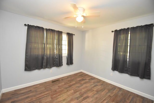 145 Deerpath St, Ozark, AL 36360 - spare room featuring a ceiling fan, baseboards, and dark wood-style floors