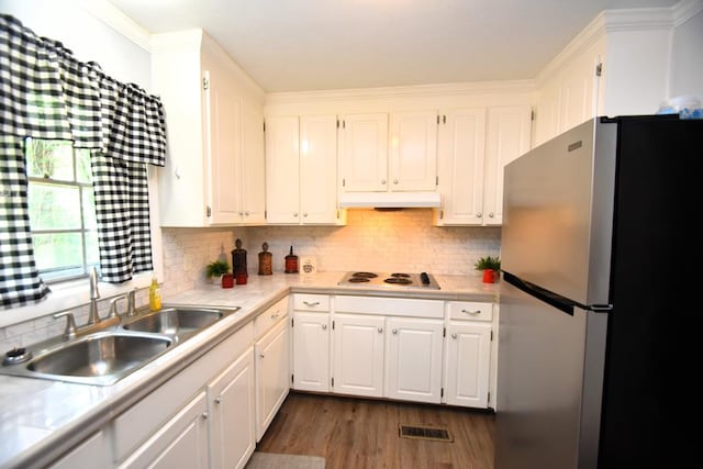 145 Deerpath St, Ozark, AL 36360 - kitchen featuring freestanding refrigerator, a sink, under cabinet range hood, electric stovetop, and white cabinets