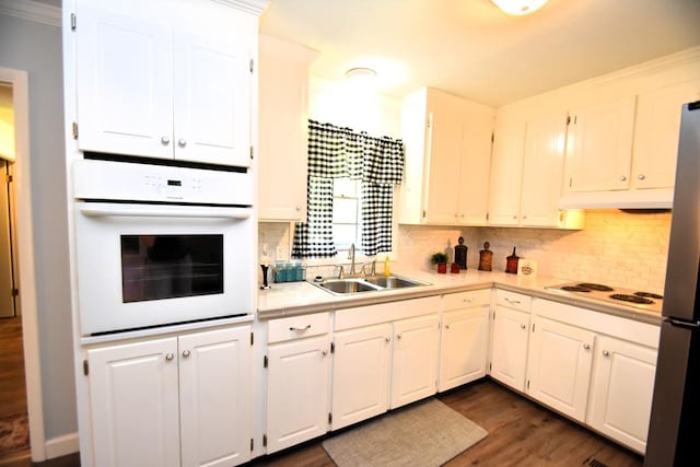 145 Deerpath St, Ozark, AL 36360 - kitchen with white appliances, light countertops, a sink, tasteful backsplash, and dark wood-style flooring
