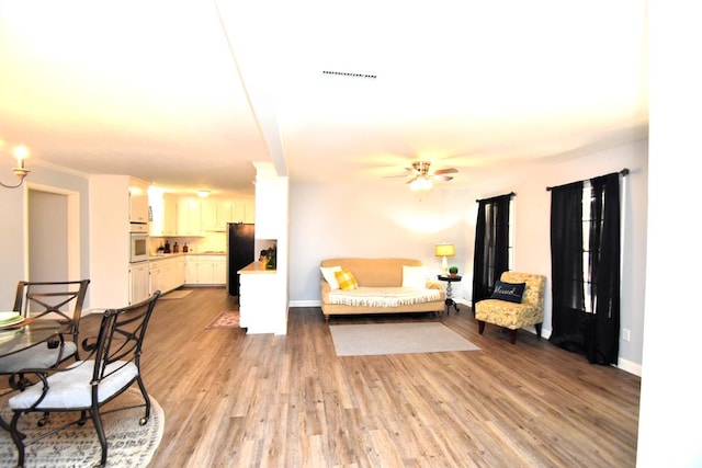 145 Deerpath St, Ozark, AL 36360 - living room with light wood finished floors, ceiling fan, and baseboards