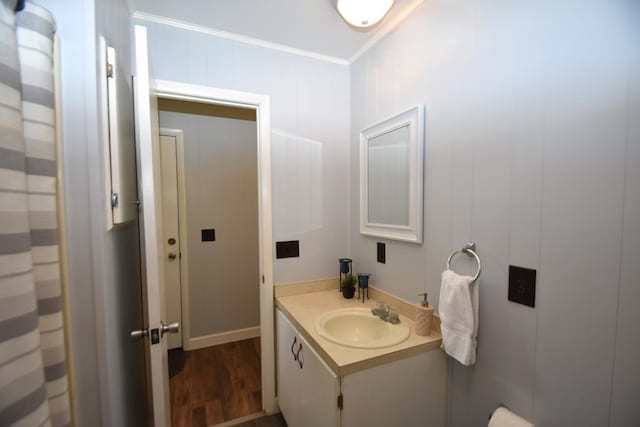 full bathroom with vanity, crown molding, and wood finished floors