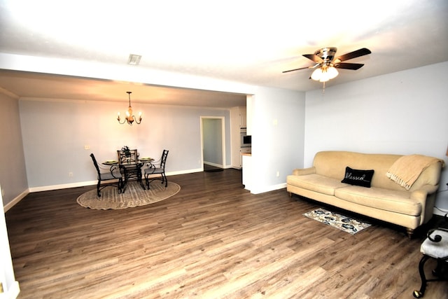 living area with baseboards, visible vents, wood finished floors, and ceiling fan with notable chandelier