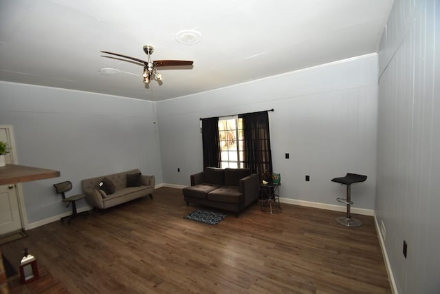 sitting room featuring baseboards, wood finished floors, and ceiling fan