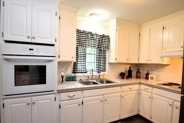 145 Deerpath St, Ozark, AL 36360 - kitchen with white appliances, a sink, under cabinet range hood, white cabinetry, and ornamental molding