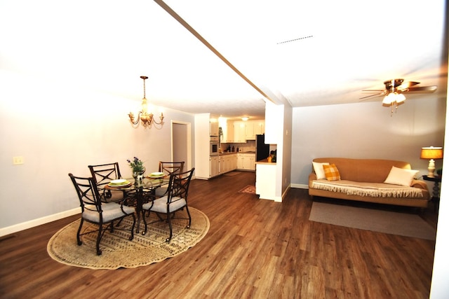 dining space featuring dark wood-type flooring, baseboards, and ceiling fan with notable chandelier