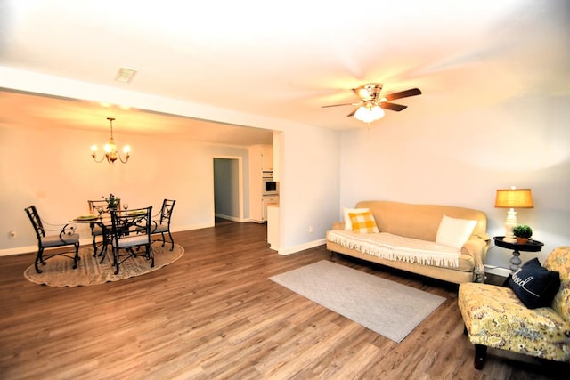 145 Deerpath St, Ozark, AL 36360 - living area with a chandelier, wood finished floors, baseboards, and ceiling fan