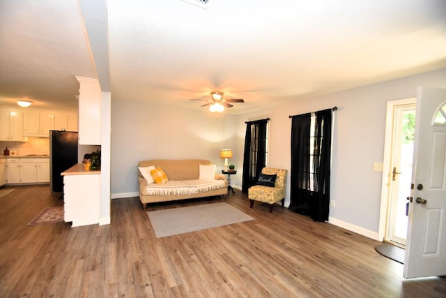 145 Deerpath St, Ozark, AL 36360 - living room featuring baseboards, a ceiling fan, and wood finished floors