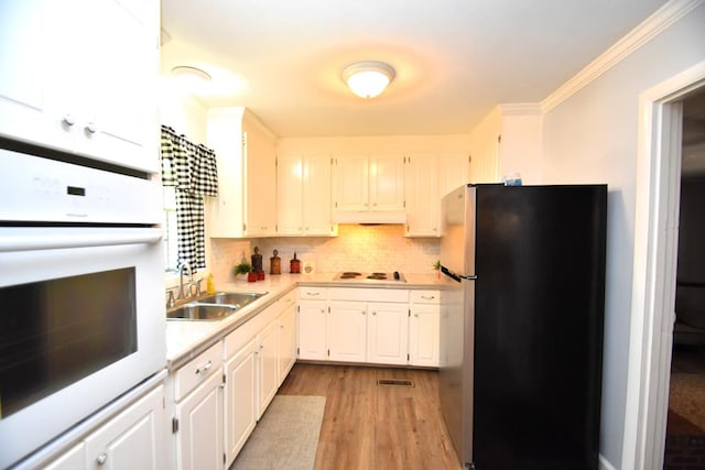 145 Deerpath St, Ozark, AL 36360 - kitchen with white appliances, a sink, light countertops, white cabinetry, and tasteful backsplash