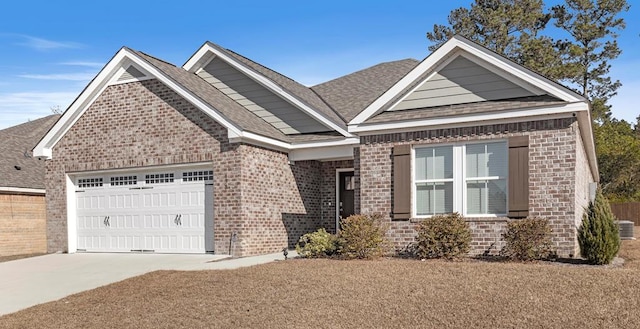 craftsman-style house featuring brick siding, concrete driveway, a garage, and roof with shingles