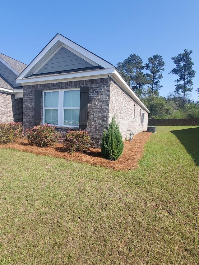 view of property exterior featuring a lawn and brick siding
