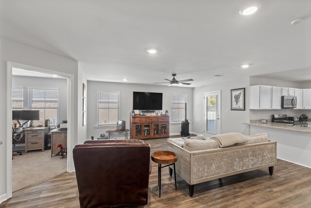 kitchen with white cabinets, dark wood-type flooring, light stone counters, and stainless steel appliances