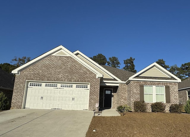view of front of home featuring concrete driveway, an attached garage, and brick siding