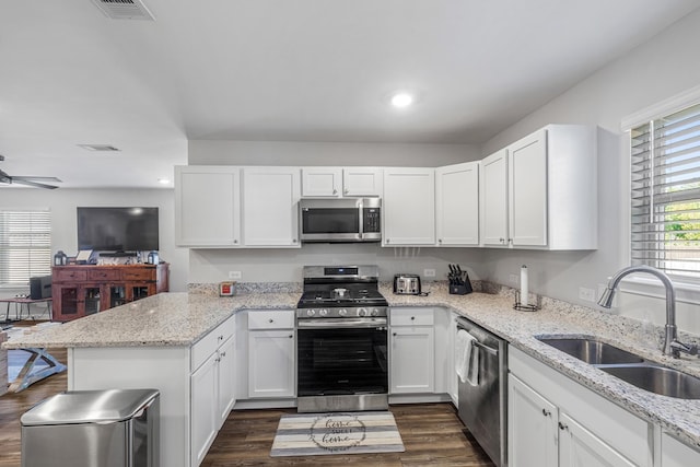 kitchen featuring stainless steel appliances, white cabinets, and sink