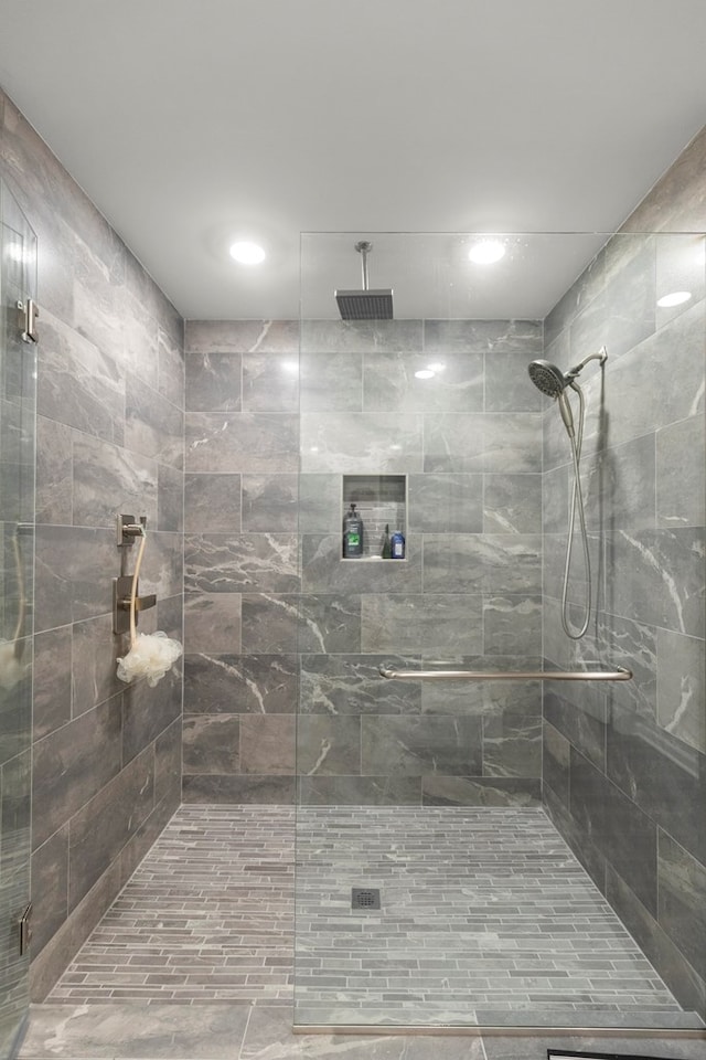 bathroom with a shower with door