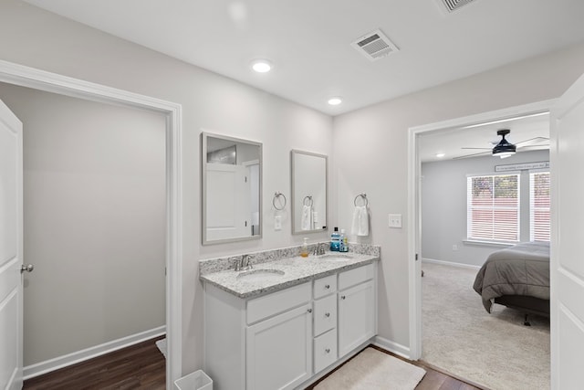 bathroom featuring ceiling fan, wood-type flooring, and vanity