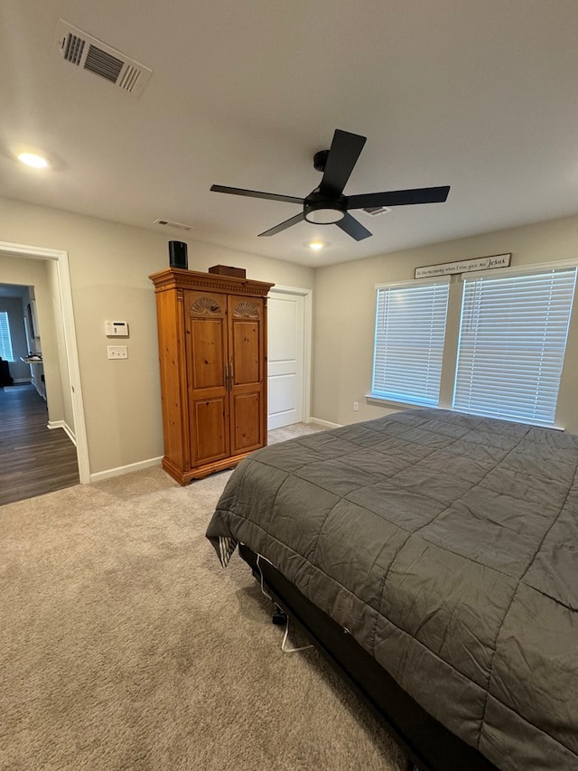 bedroom featuring ceiling fan and light carpet