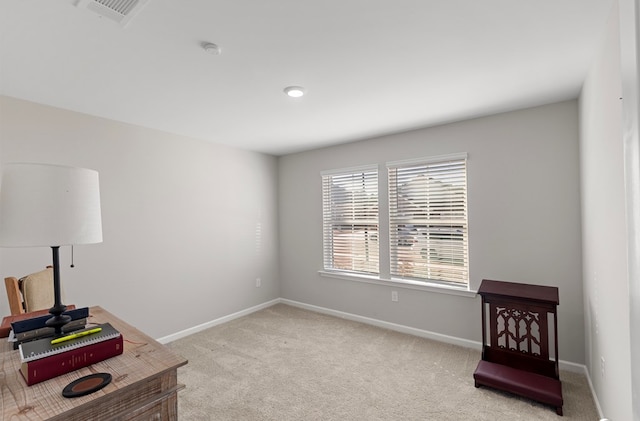 sitting room featuring light colored carpet