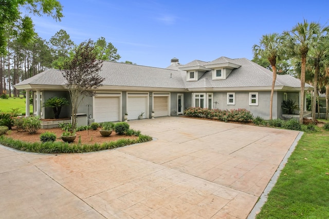 109 Royal Highlands Ln, Dothan, AL 36305 - view of front of property featuring a garage, concrete driveway, stucco siding, a chimney, and a shingled roof
