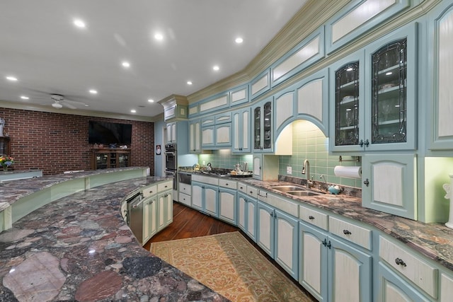 109 Royal Highlands Ln, Dothan, AL 36305 - kitchen with crown molding, dark wood finished floors, a ceiling fan, dark stone countertops, and glass insert cabinets