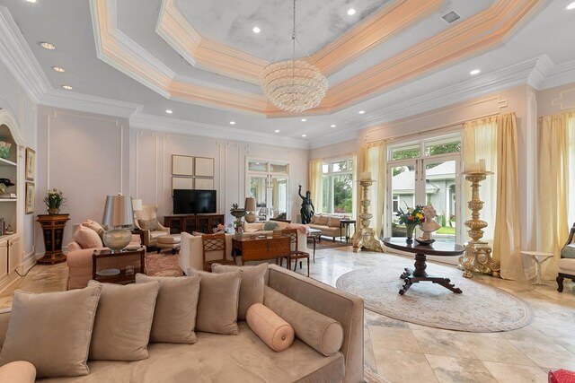 109 Royal Highlands Ln, Dothan, AL 36305 - living room featuring a chandelier, crown molding, a tray ceiling, and a towering ceiling
