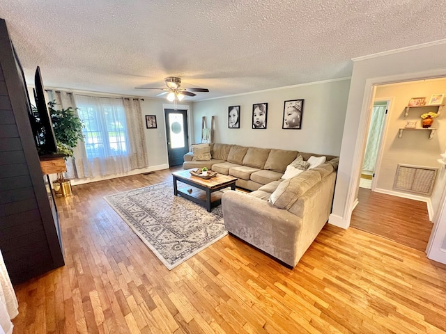 601 6th Ave, Ashford, AL 36312 - living area with a textured ceiling, light wood-style flooring, crown molding, and ceiling fan
