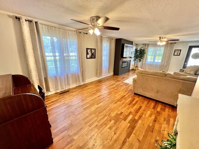 601 6th Ave, Ashford, AL 36312 - living room with ceiling fan, a textured ceiling, and light wood-style flooring