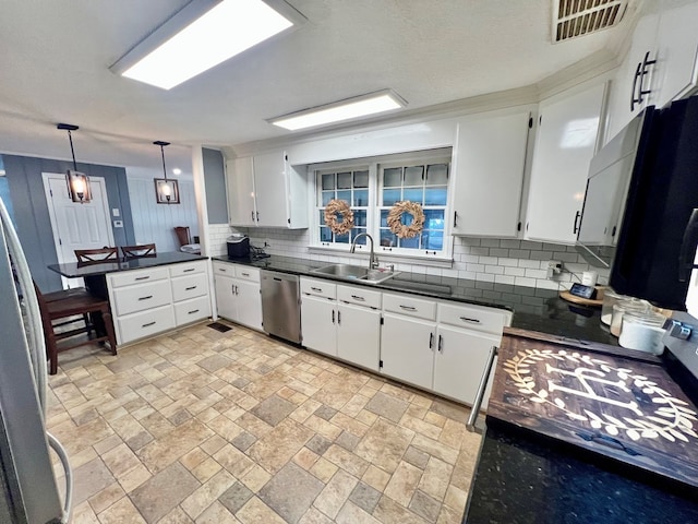 601 6th Ave, Ashford, AL 36312 - kitchen with dishwasher, decorative backsplash, dark countertops, and a peninsula