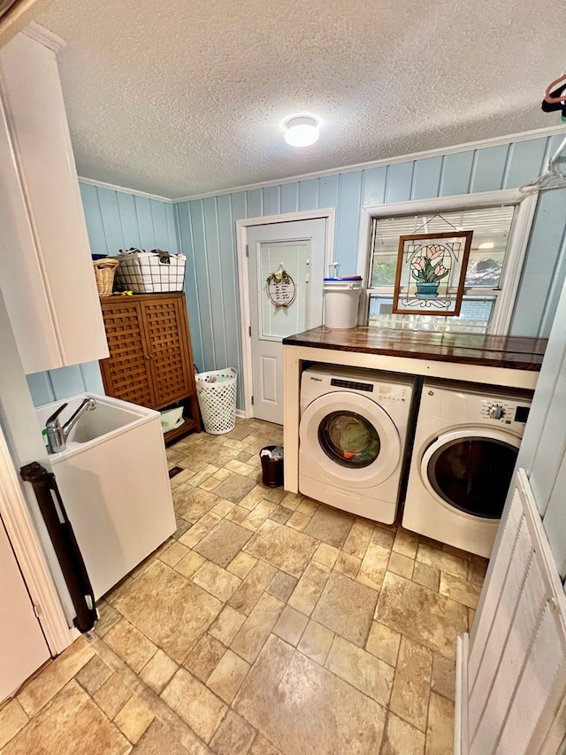 601 6th Ave, Ashford, AL 36312 - laundry room with washer and clothes dryer, cabinet space, stone tile floors, and a textured ceiling