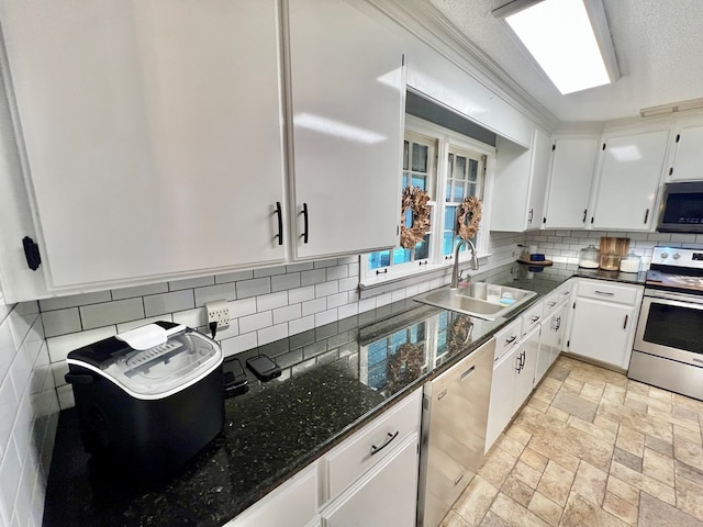 601 6th Ave, Ashford, AL 36312 - kitchen featuring appliances with stainless steel finishes, white cabinets, backsplash, dark stone counters, and light stone finish floors