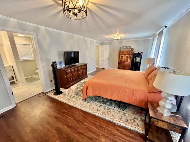 601 6th Ave, Ashford, AL 36312 - bedroom with ornamental molding, wood finished floors, a chandelier, and ensuite bathroom