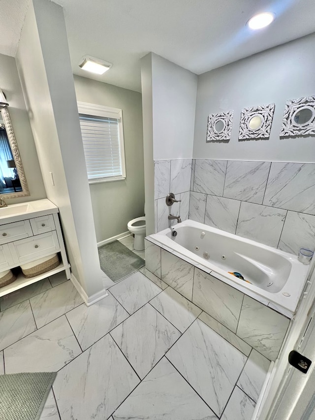 601 6th Ave, Ashford, AL 36312 - bathroom with marble finish flooring, vanity, a jetted tub, and healthy amount of natural light