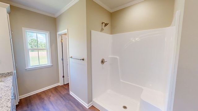 bathroom with a shower, wood-type flooring, and crown molding