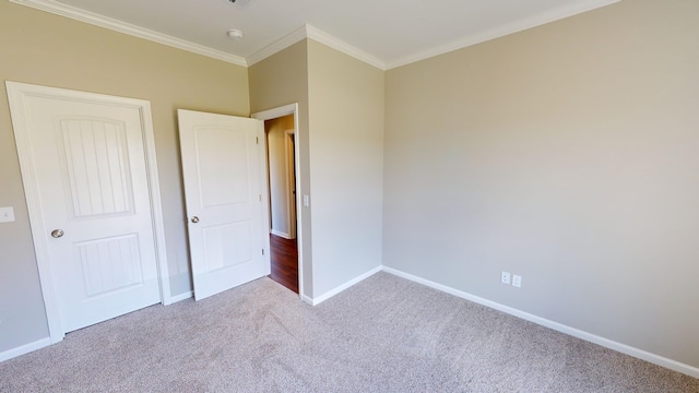 unfurnished bedroom with light colored carpet and ornamental molding