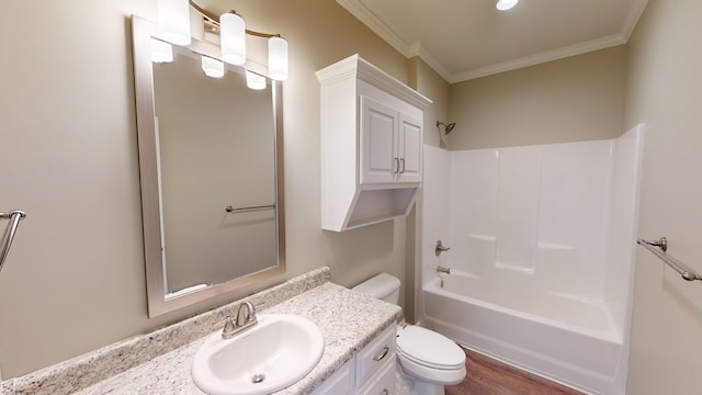 full bathroom featuring ornamental molding, vanity, bathing tub / shower combination, wood-type flooring, and toilet