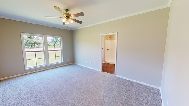 carpeted empty room with ceiling fan and crown molding