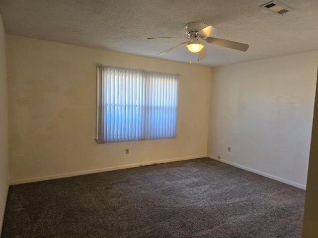 carpeted empty room featuring ceiling fan and a textured ceiling