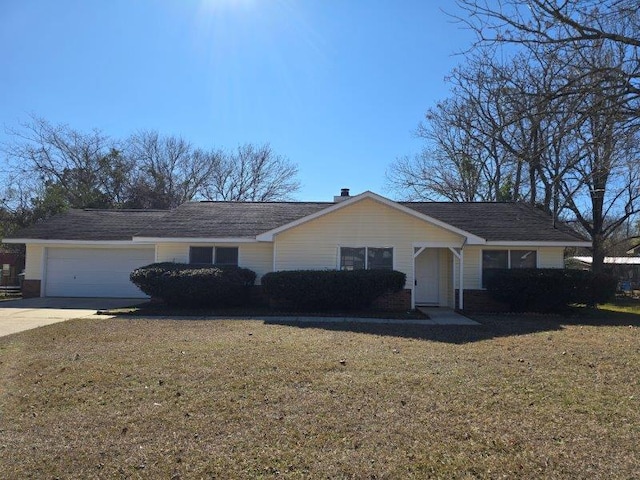 ranch-style home featuring a garage and a front lawn