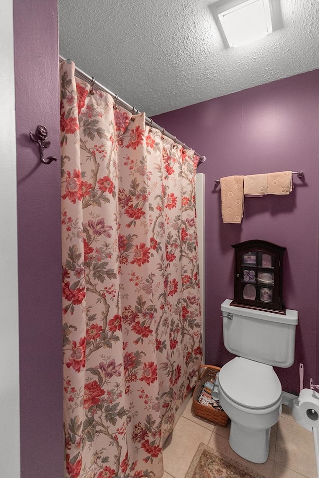 303 Denise St, Dothan, AL 36305 - bathroom with toilet, a textured ceiling, tile patterned floors, and curtained shower