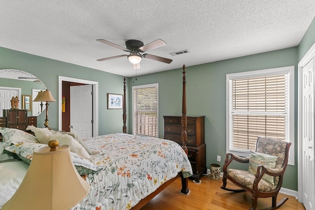 303 Denise St, Dothan, AL 36305 - bedroom with wood finished floors, a textured ceiling, and a ceiling fan