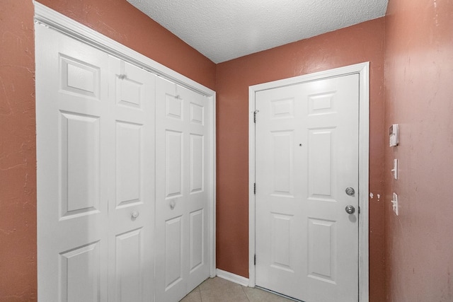 303 Denise St, Dothan, AL 36305 - entrance foyer featuring a textured ceiling, light tile patterned floors, and baseboards
