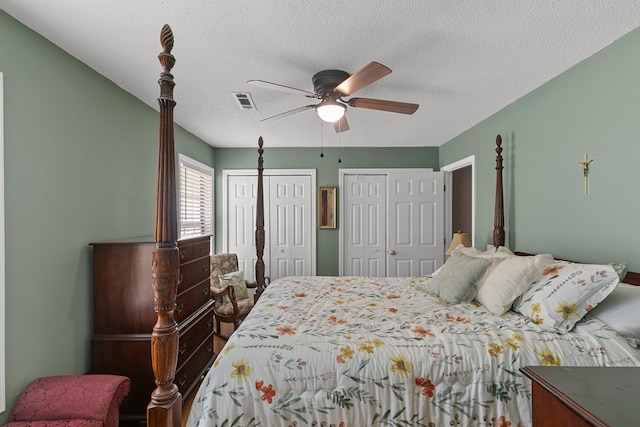 303 Denise St, Dothan, AL 36305 - bedroom featuring multiple closets, a textured ceiling, and ceiling fan