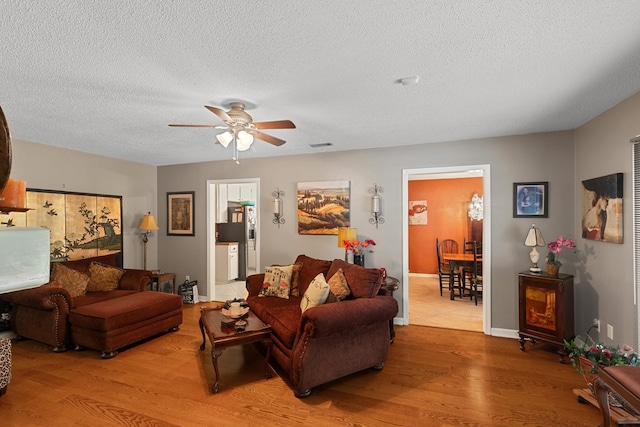 303 Denise St, Dothan, AL 36305 - living area featuring wood finished floors, ceiling fan, a textured ceiling, and baseboards