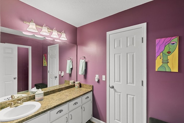 303 Denise St, Dothan, AL 36305 - bathroom with vanity, a textured ceiling, and baseboards