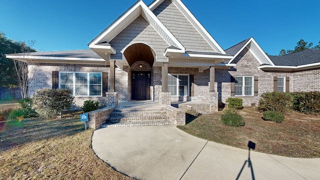 view of front of property with covered porch and a front yard