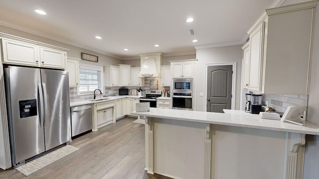 kitchen with a breakfast bar, custom range hood, stainless steel appliances, and tasteful backsplash